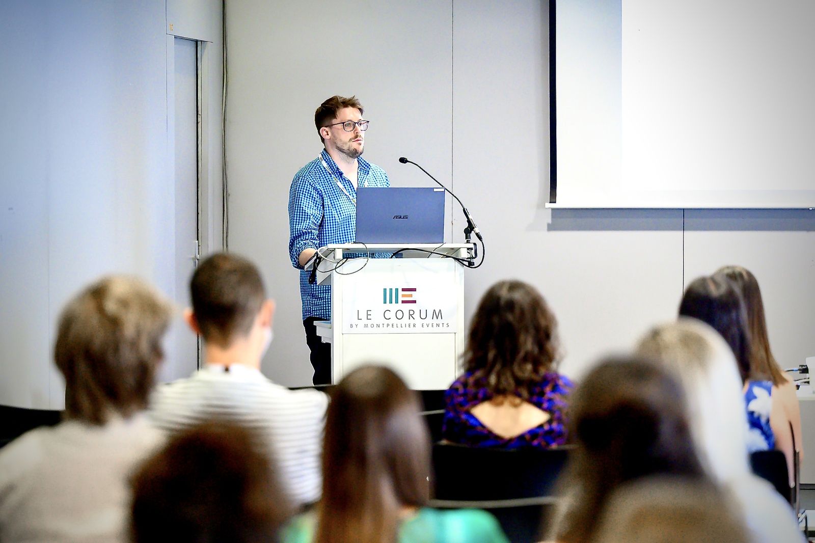 Edward Ivimey-Cook giving a talk at a lectern to a seated audience